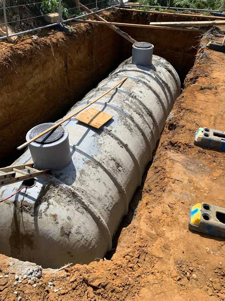 Large concrete underground tank in an excavated trench