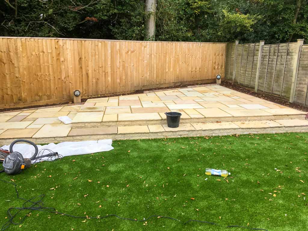 Large paved garden patio with raised steps