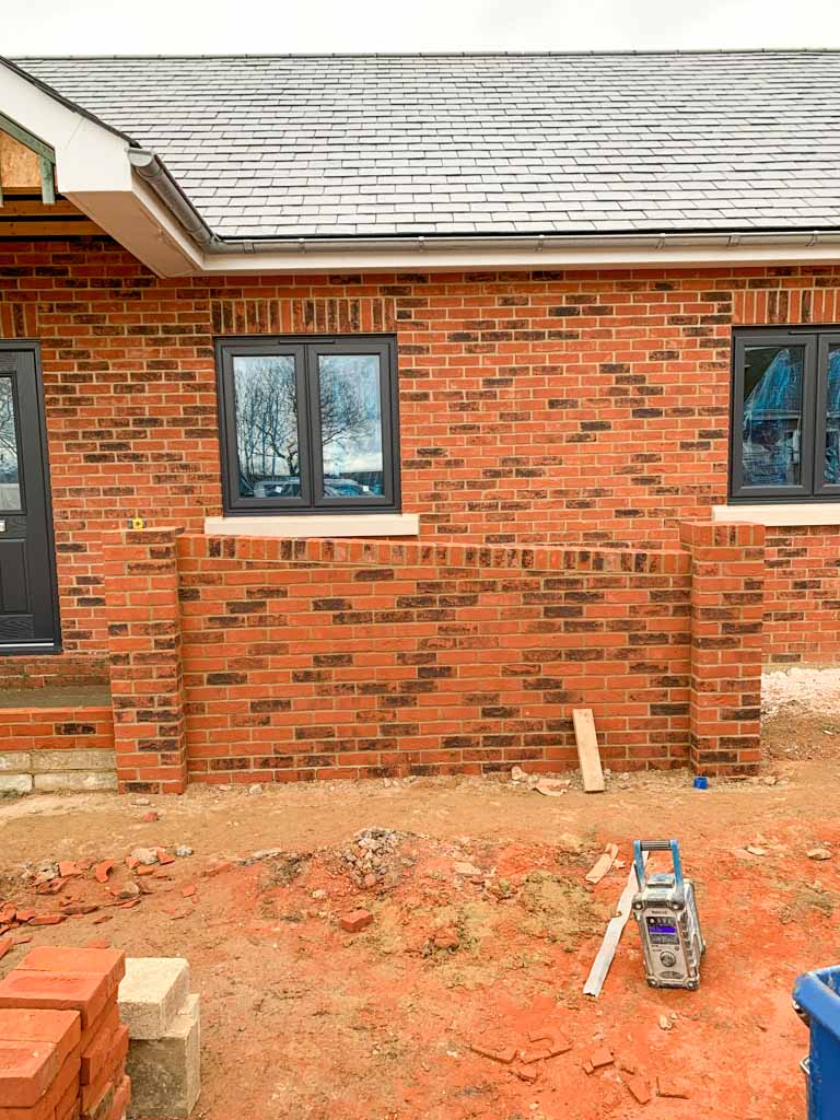 New red brick house with matching front wall